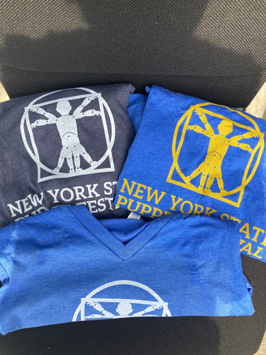 Three folded t-shirts, one navy with white ink, one royal blue with yellow ink, one royal blue with white ink, saying New York State Puppet Festival with the logo of a puppet